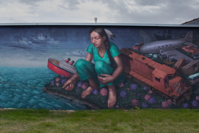 “Both Immigrant and Not: Coming Home” by Peter Daniel Bernal. The mural features the artist's mother as a young Native American girl