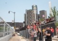 Grand stand fans watching the Detroit Grand Prix with the Renaissance Center in the background