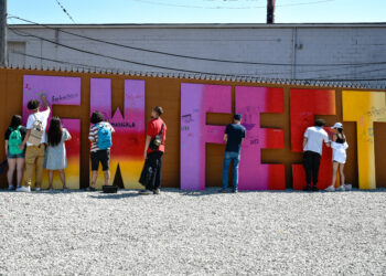a group of people decorating big letters for the Southwest Fest