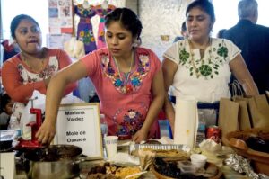 Mariana Valdes (center) from Oaxaca has won three out of four years at Holy Mole! mole contest. Photo by Elisa Limon.
