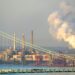 Detroit, Mich./USA-July 18, 2018: industrial area of southwest Detroit visible beyond the Detroit River and partial view of the Ambassador Bridge