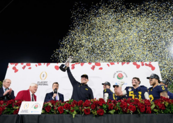 Photo is head coach Jim Harbaugh raising the Rose Bowl trophy after defeating the Crimson Tide. Photo provided by the University of Michigan Wolverines Athletics Department