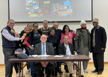 Photo of Mario Grillo (right seated at table)with Bomba group RicanStruction and Jorge Chinea from Center for Latino Studies and Ollie Johnson from African American Studies