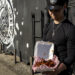 Daniel Fuentes holds a serving of Pollo a las Brasas during a pop-up event