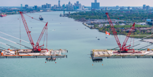 The dramatic drone photo of the 85’ gap between the American and Canadian bridge decks with downtown Detroit and Windsor, Ontario in the background was captured by Andrew Dean Detroit.
