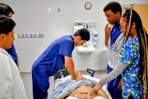 RYSE MED High School Scholars practicing hands-only CPR