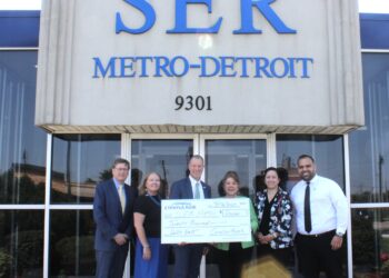 Steve Davis, Michigan Market President of Comerica Bank, pictured third from left, presents a check for $20,000 to SER Metro-Detroit leadership, from left, David Cunningham, Ann Leen, Eva Garza Dewaelsche and Veronica Sanchez Peavey. Pictured at far right, Hassan Melhem, Vice President - External Affairs, National Middle Eastern American Business Development at Comerica
