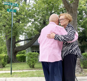 Joe and Siliva Saldivar (sister of Martin Solis) dance in front of the new street sign.