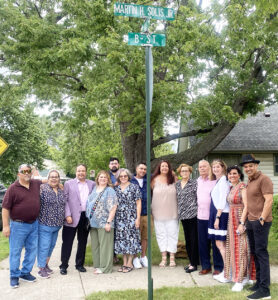 Family and friends of Martin Solis stand beneath the new street sign.