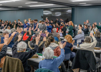 Strangers No Longer high school and parish Circles of Support bless immigrants and each other at a recent gathering. Photo provided by Strangers No Longer