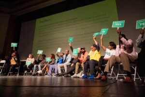 School board candidates raise signs indicating their positions on various community issues