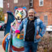 Local visual artist Elton Monroy Duran proudly displays one of five Alebrijes sculptures unveiled on the Bagley Streetscape in Mexicantown. Photo by Alejandro Ugalde