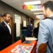 Andre Mitchell, a community engagement coordinator with Freedom House Detroit, goes over resources at the October 16 BridgeDetroit refugee/immigrant resource fair. Credit: Quinn Banks, Special to BridgeDetroit
