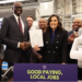 Gov. Gretchen Whitmer holds up the Michigan Innovation Fund bills signed into law this week flank