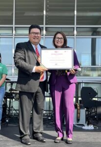 Mexican Consul Roberto Nicolas presents the Ohtli Award to Luz Acosta at the Grito Ceremony in Mexicantown in September 2024