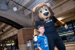 A young Lions fan gives Roary a hug.