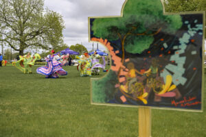 A painted puzzle piece artwork is displayed as Ballet Folclórico of Wayne State University dancers perform at Roosevelt Park during the ‘Pieces of Detroit’ event in Detroit, Michigan, on April 27, 2025. The installation and performances celebrated the cultural and historical ties across Southwest Detroit.