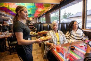 Server Angelina Celestee delivers tacos and handmade sopes to diners at La Jali in Taylor, MI., on Monday, May 5, 2025