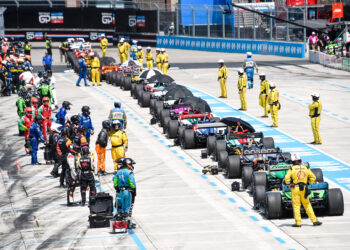 All racers pull into pit lane to wait as wreckage from a crash is cleared from the course so the final laps can be run.
