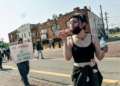 DETROIT, MI - JUNE 14, 2025: A protestor blows bubbles as a few thousand Metro Detroit activists march from Clark Park to a Detroit Federal Building near downtown Detroit, MI for No Kings Day on June 14, 2025 to show support for the immigrant community, denounce the rise of authoritarianism and the ongoing ICE raids, and to show solidarity with Los Angeles after President Trump deployed the National Guard and U.S. Marines to L.A. in response to large scale protests.