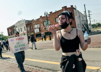 DETROIT, MI - JUNE 14, 2025: A protestor blows bubbles as a few thousand Metro Detroit activists march from Clark Park to a Detroit Federal Building near downtown Detroit, MI for No Kings Day on June 14, 2025 to show support for the immigrant community, denounce the rise of authoritarianism and the ongoing ICE raids, and to show solidarity with Los Angeles after President Trump deployed the National Guard and U.S. Marines to L.A. in response to large scale protests.