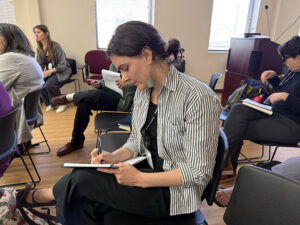 Planet Detroit reporter Isabelle Tavares takes notes during a workshop session.