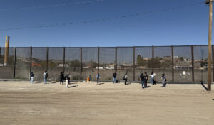 The group of workshop participants—TV anchors, radio producers, digital journalists—learn about the history of the border.