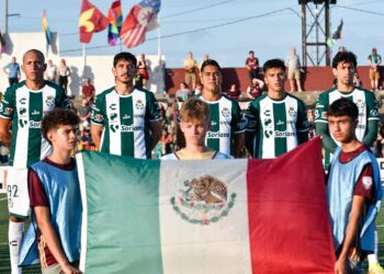 Club Santos Laguna players stand for the playing of the Mexican national anthem.