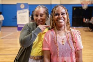 Kim Partee (left) with the Michigan Department of State celebrates with Alicia Kelley of Pontiac (right). Kelley left the Southwest Detroit clinic with her driver’s license fully reinstated. Photo provided Michigan Secretary of State