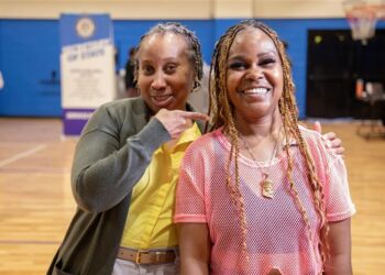 Kim Partee (left) with the Michigan Department of State celebrates with Alicia Kelley of Pontiac (right). Kelley left the Southwest Detroit clinic with her driver’s license fully reinstated. Photo provided Michigan Secretary of State
