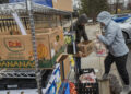 Volunteers collect fresh food to deliver to immigrant families.