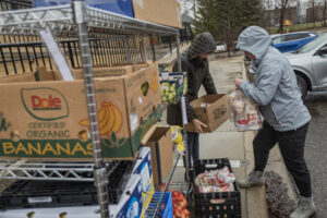 Volunteers collect fresh food to deliver to immigrant families.