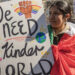 Protester holds a sign stating “We need a kinder world” at No Kings Demonstrations