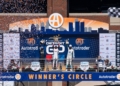Alex Palou (Spain, #10) celebrates his first place victory at the 2026 Detroit Grand Prix alongside second place Kyle Kirkwood (USA, #27), and third place Graham Rahal (USA, #15) on top of the winners circl