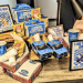 Detroit Lions branded merchandise and kids meal display featuring blue and gold Lions boxes, Lay's chips bags, toy Ford F-150 trucks, napkins, and promotional signage for Lions Kids Meal and Ford products.